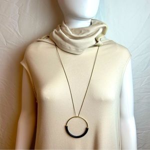 Brass Color ring pendant bound with black leather necklace.